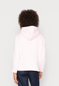 Felpa rosa con cappuccio regolabile, tasca frontale e polsini a costine. Tessuto morbido, vestibilità ampia e design semplice senza motivi visibili.