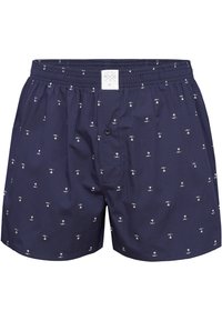 Boxers bleu marine en tissu doux, avec un motif de palmiers blancs, une taille élastique et une fermeture à bouton à l'avant.