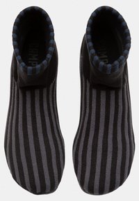 Black and gray striped socks with ribbed top, featuring a smooth texture and a fitted shape, designed for comfort and warmth.