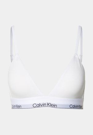 White triangle bralette made of soft fabric, featuring adjustable straps and a black Calvin Klein logo band along the underband.