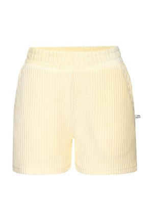 Cremefarbene, gerippte Strickshorts mit elastischem Bund und kleinem Seitenschild auf schlichten weißem Hintergrund.