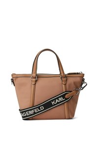 Tan tote bag with dual top handles and a detachable black strap featuring white text. Made of smooth material with zip closure.