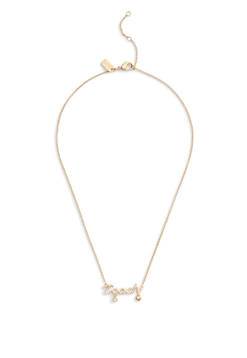 Collier ton or avec le mot "coach" en cursive, accompagné d'un petit cœur pendu et d'un accent en pierre précieuse. Chaîne fine avec fermoir.