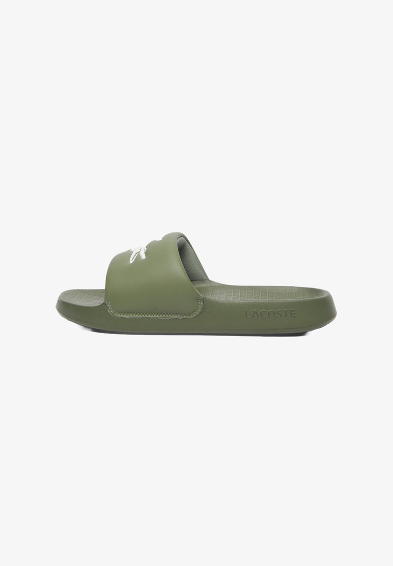 Green rubber slide sandal with a wide strap, featuring a small white logo on the front and textured sole for grip.