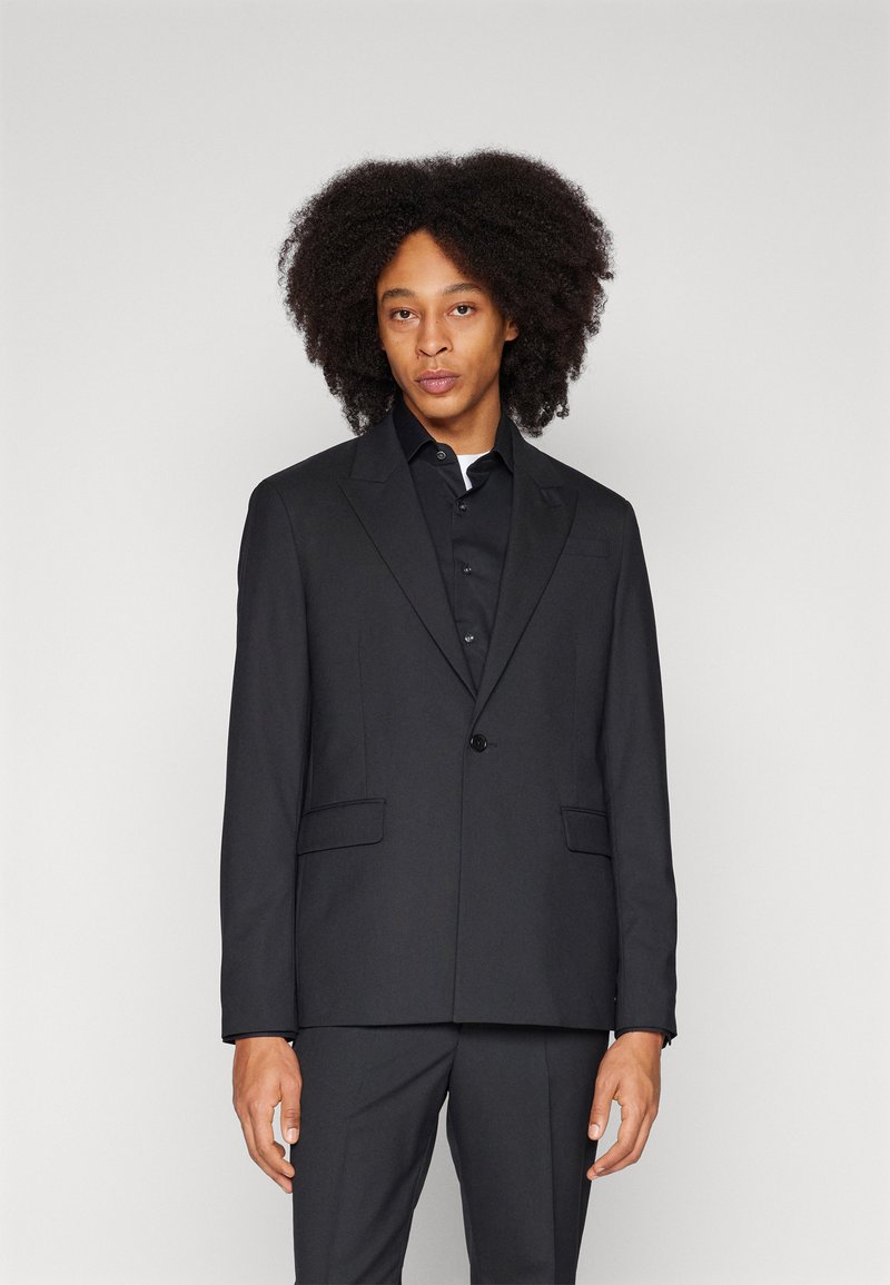 Black blazer with a smooth texture, single button closure, notch lapels, and two front pockets, paired with a matching shirt.