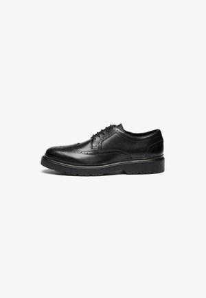 Black leather dress shoe with brogue detailing, rounded toe, and textured sole. Features classic lacing and a sturdy heel for support.