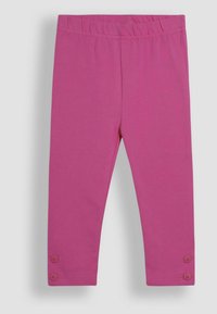Rosa leggings gjorda av mjuk bomull med elastisk midja och dekorativa knappdetaljer vid fållen. Slät textur och åtsittande design.