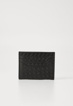 Black leather cardholder with woven texture, featuring four card slots and a debossed logo. Rectangular shape, glossy finish.