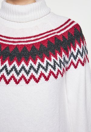 Pulover cu guler înalt tricotat, de culoare albă, cu un design superior cu modele în zigzag roșu, negru și alb. Textură moale, croială lejeră.
