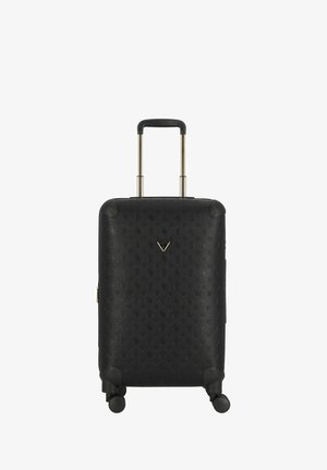 Black hard-shell suitcase with patterned texture, retractable handle, and four black wheels. Features a metallic logo on the front.