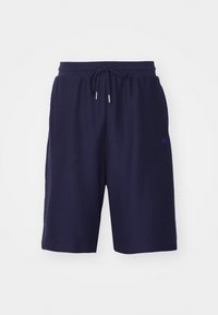 Shorts en coton bleu marine avec une taille élastique à cordon de serrage, tissu texturé et un petit logo violet sur la jambe gauche.