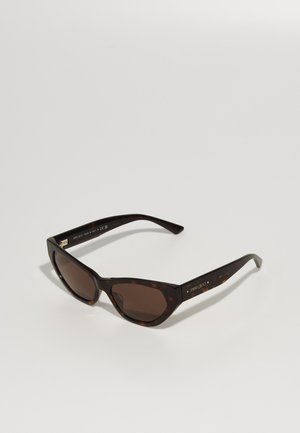 Cat-eye sunglasses with a tortoiseshell pattern, dark brown lenses, and smooth plastic frames. Branding visible on the inside of the arms.