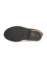 Shoe bottom features a black rubber outsole with a diamond tread pattern and a light brown upper section. Sturdy heel and adjustable strap included.