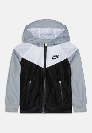 Hooded jacket made of smooth material in black, gray, and white, with a zipper, side pockets, and a Nike logo on the chest.