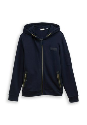 Navy Zip-Hoodie aus Baumwollmischung. Mit gefütterter Kapuze, goldenen Reißverschlussdetails, zwei seitlichen Taschen und einem Patch auf dem linken Arm.