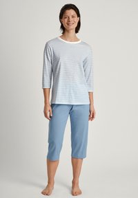 Striped long-sleeve top in white and light blue, paired with solid light blue capri pants. Fabric appears soft and lightweight.