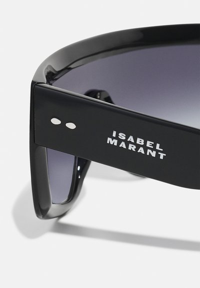 Black oversized sunglasses with dark gradient lenses, featuring a thick frame and the brand name "Isabel Marant" in white text on the side.