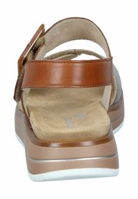 Brown leather sandals with a supportive back strap, cushioned beige footbed, and a chunky white outsole. Features a buckle for adjustment.