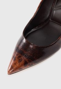 Pointed toe high heel shoe with a brown snakeskin pattern. Glossy finish with a smooth interior and a slight curve at the opening.