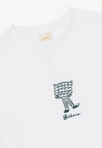 White cotton t-shirt featuring a green embroidered graphic of a character with a spiral head and whimsical legs, accompanied by "BLKVIS" text.