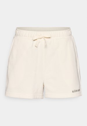 Kreemivärvi lühikesed püksid pehmest kangast, millel on elastne vöökoht paelaga, küljetaskud ja väike logo ääres.