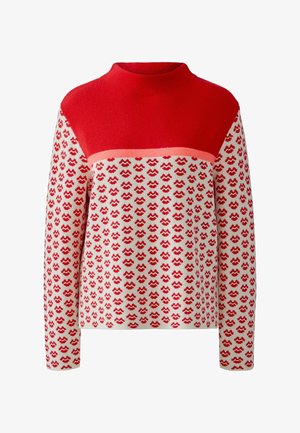 Red and cream knit sweater with high neckline, featuring a repeating red pattern and solid red upper section. Soft texture, long sleeves.