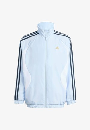 Veste de survêtement Adidas bleu clair avec bandes noires sur les épaules, fermeture éclair intégrale à l'avant, poignets élastiques et logo Adidas doré sur la poitrine.
