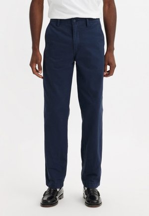Pantalons en coton bleu marine avec une coupe droite. Dotés d'une fermeture à bouton et de deux poches avant. Tissu texturé avec une finition lisse.