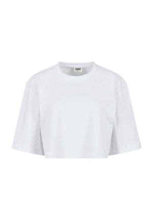 T-shirt blanc court en coton doux. Il présente un col rond et des manches courtes avec une coupe décontractée, sans motifs ni éléments métalliques visibles.