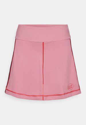 Pink athletic skirt with a smooth texture, featuring a fitted waistband, contrasting red stitching, and a logo on the lower right side.