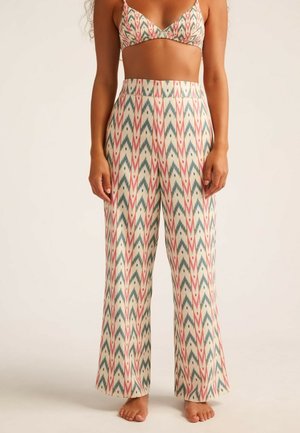 Pantalones palazzo estampados con un fondo crema y diseños en zigzag en rosa y verde azulado. Fabricados en tejido ligero, con un corte relajado.