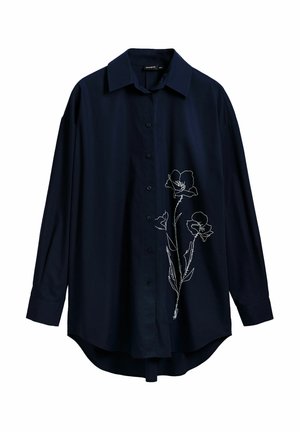 Navy blue button-up shirt in soft fabric with long sleeves. Features white floral embroidery on the left side and a curved hemline.