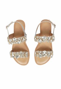 Sandali argento con cinturini, con suola in pelle nude, dotati di molteplici decorazioni in cristalli trasparenti sui cinturini e una chiusura alla caviglia con fibbia.