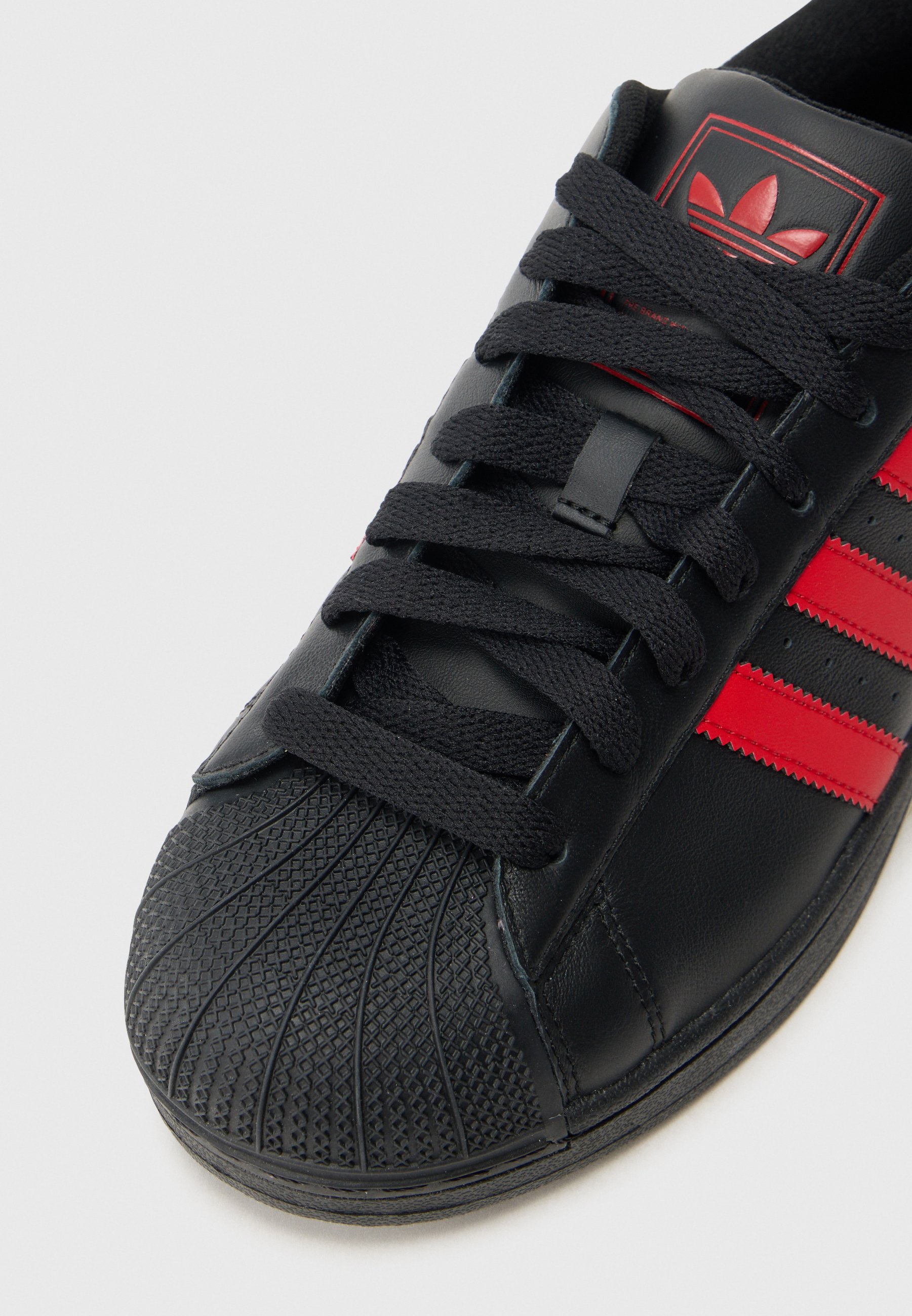 shell toe adidas black and red