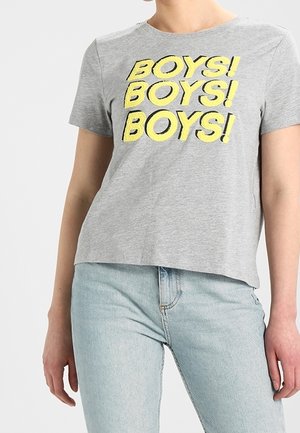 Grå T-shirt med korte ærmer og fed gul tekst "BOYS! BOYS! BOYS!", båret med lyseblå jeans, vist fra nakke til hofter.
