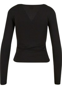 Långärmad svart topp med en åtsittande design, tillverkad av stretchigt material. Har en V-skärning på baksidan och en mjuk textur.