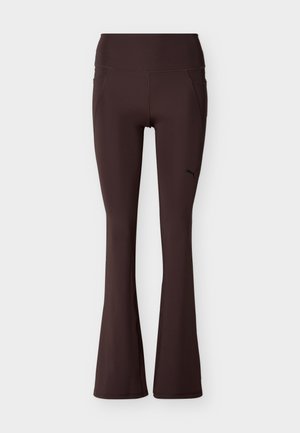 Dunkelbraune, ausgestellte Sportleggings mit hohem Bund und kleinem Puma-Logo auf dem oberen linken Oberschenkel.