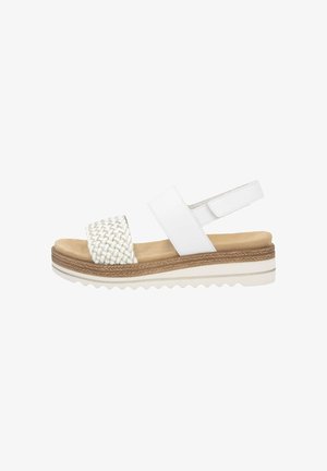 White sandals with a woven strap, adjustable ankle strap, and a textured platform sole. Features a light tan interior and braided accent.