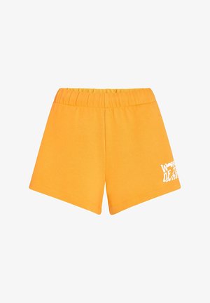 Kollased puuvillased lühikesed püksid elastse vöökujuga ja valge graafilise printimisega vasakul jalal. Sirge serv ja pehme tekstuur.