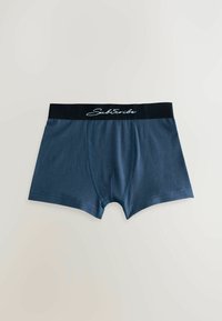 Dunkelblaue Boxershorts aus glattem Stoff, mit einem schwarzen elastischen Bund, der den weißen Text "Abonnieren" und kontrastierende Nähte zeigt.