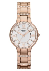 Rose gold metalur ur med en rund, sølvfarvet skive. Krystaltouch rundt om bezel og skive markører. Romerske tal ved 12, 3, 6, 9.