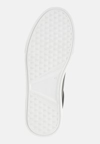 Black sneaker with a white rubber outsole, featuring a textured grip pattern and a size marked "42." The design is sleek and contemporary.