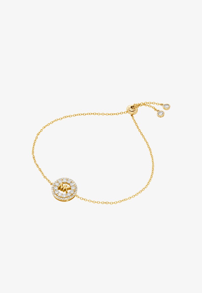 Kultaketju, jossa on pyöreä keskipiste, jota koristaa kirkkaiden jalokivien halo ja keskellä teksturoitu kultakoriste.