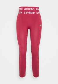 Rosa träningsleggings med en bred, märkes-logo midja. Slät textur med ribbade detaljer på sidorna och en liten logotyp på underbenet.