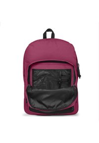Bordeaux-ryggsäck med ett stort huvudfack, svart inre ficka och nätorganisatörer. Utrustad med ett handtag på toppen och dragkedjor.