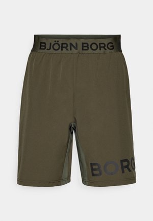 Olíva zöld sportnadrág fekete elasztikus derékkal, rajta a "BJÖRN BORG" logóval, sima anyagból készült és karcsú szabású.