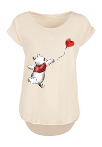 Beige short-sleeve T-shirt featuring a graphic of a bear in a red scarf reaching for a red heart balloon. Soft fabric with a loose fit.