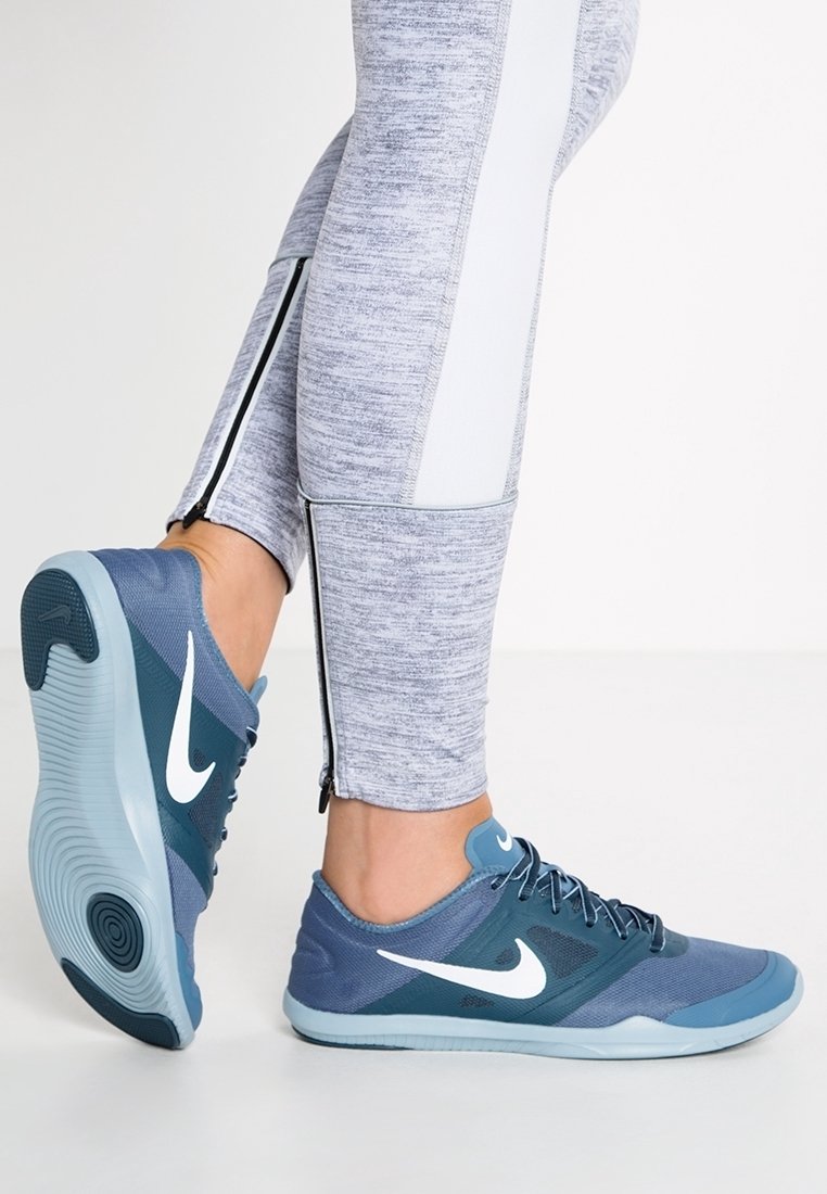 Blue Nike athletic shoes with mesh and synthetic material, featuring a white swoosh logo and a textured sole, paired with gray leggings.