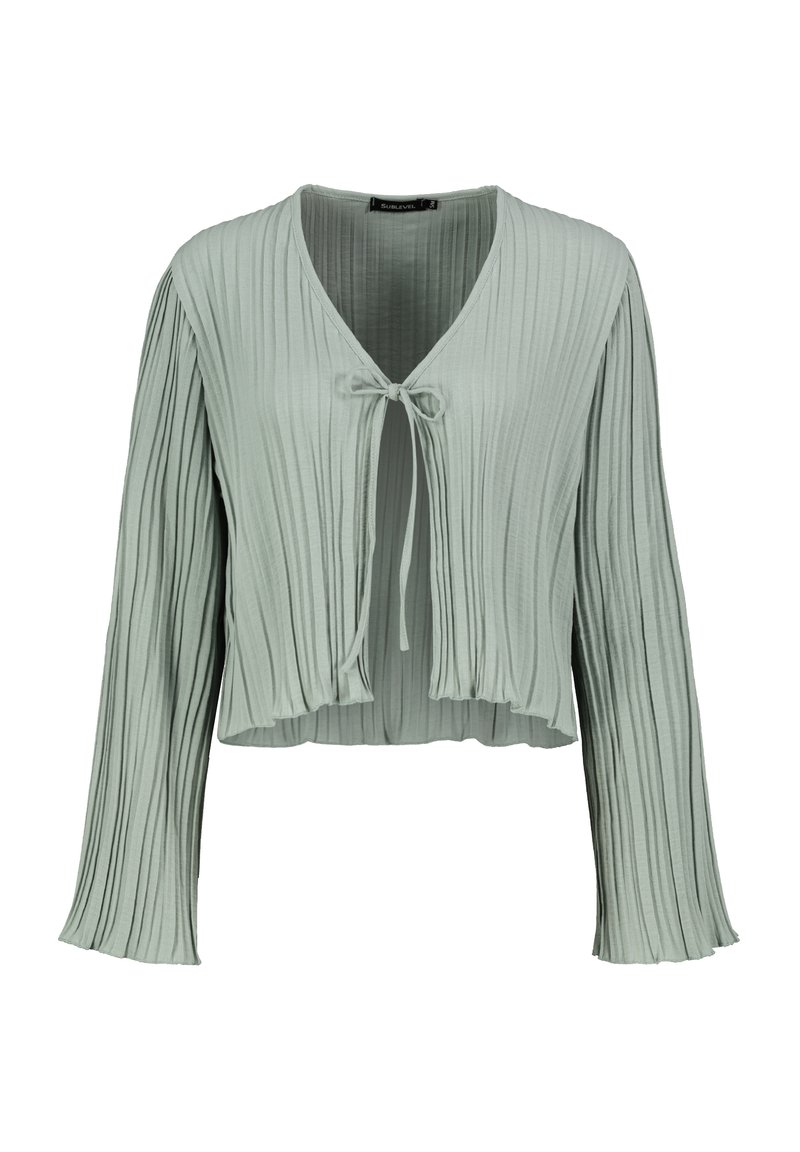 Light green pleated cropped jacket with long sleeves, v-neckline, and tie closure at the front. Soft fabric with a textured finish.
