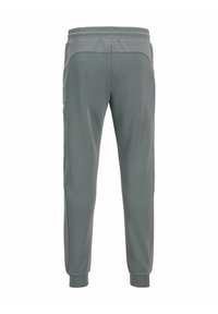 Graue sportliche Jogginghosen mit schmal zulaufendem Bein, elastischem Bund und strukturierten seitlichen Einsätzen. Hergestellt aus einem weichen, atmungsaktiven Stoff.